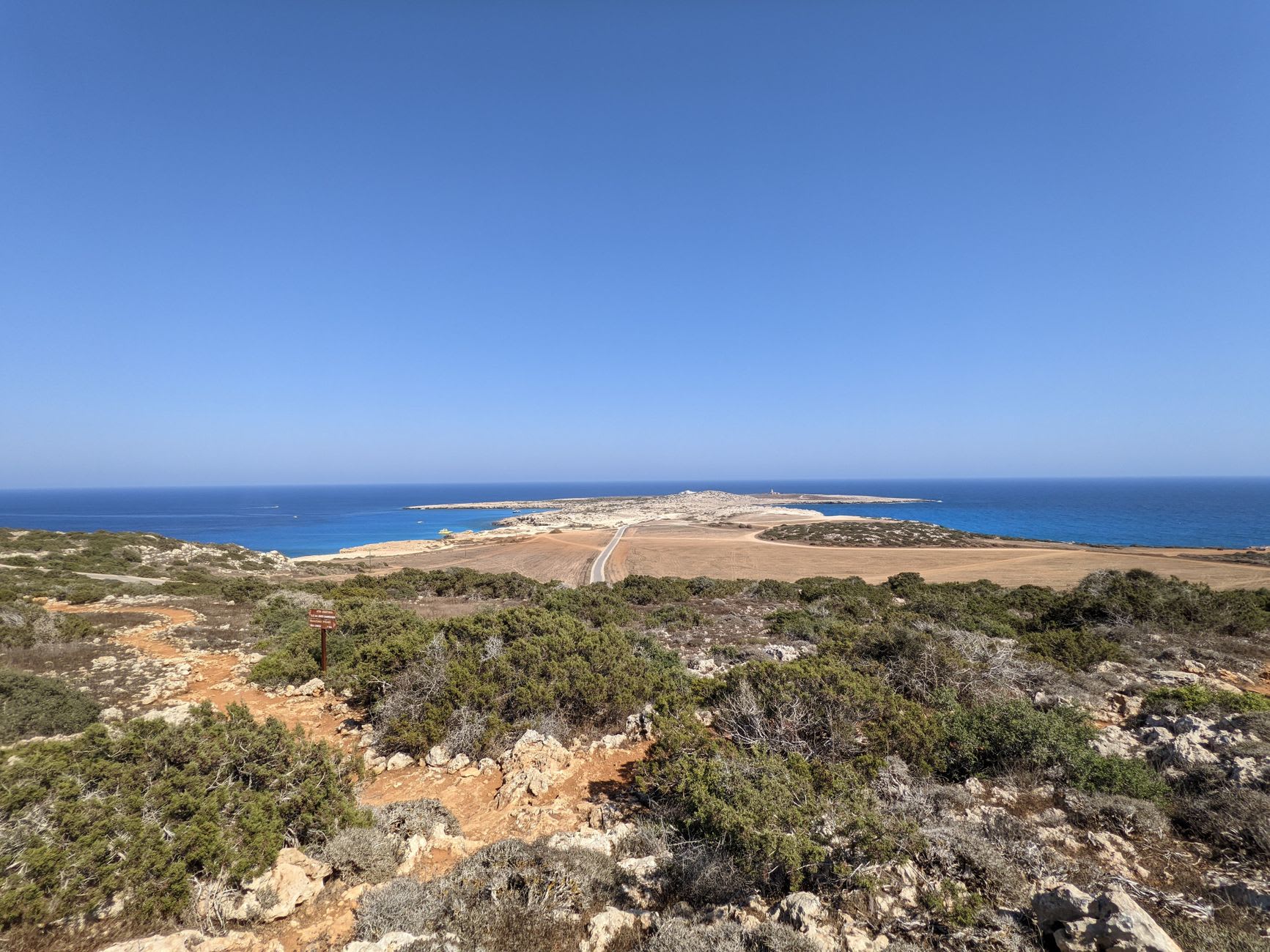 Nangomi Bay, Karpaz Peninsula, an empty golden sand beach with nobody on it, the shallow turquoise sea stretching to the horizon