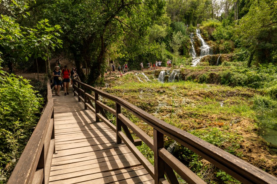 Wooden boardwalk winding through the terraced waterfalls at Skradinski buk in Krka National Park