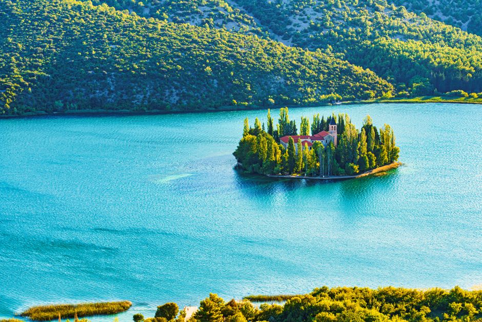 Franciscan monastery on Visovac Island surrounded by the calm waters of the Krka River