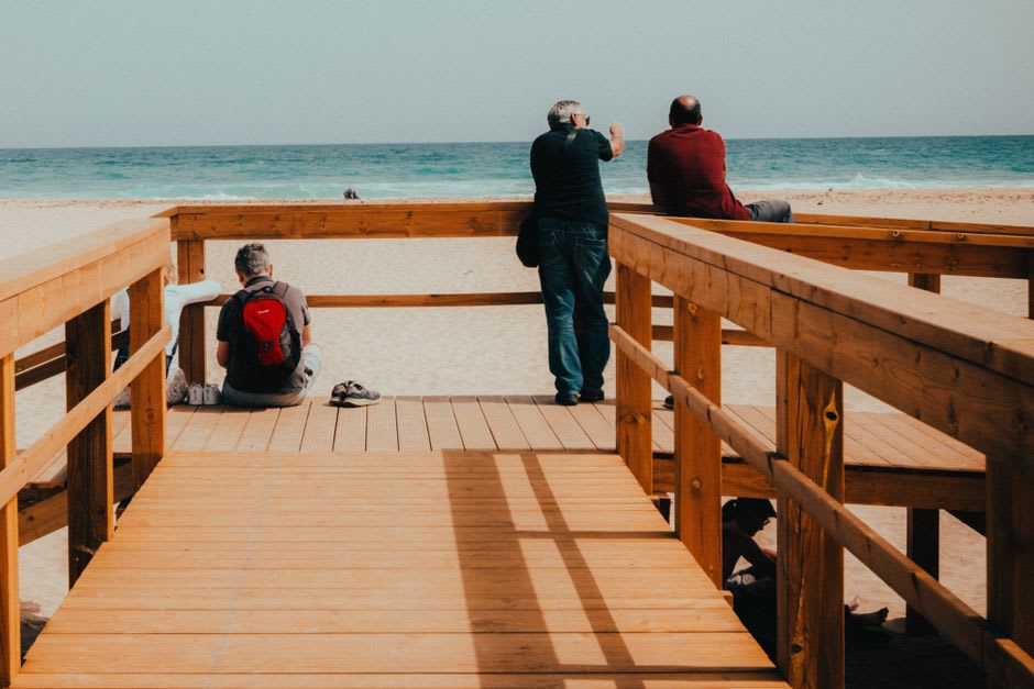 The wooden walkway and shaded rest areas at Kalia Beach leading down toward the Dead Sea shoreline