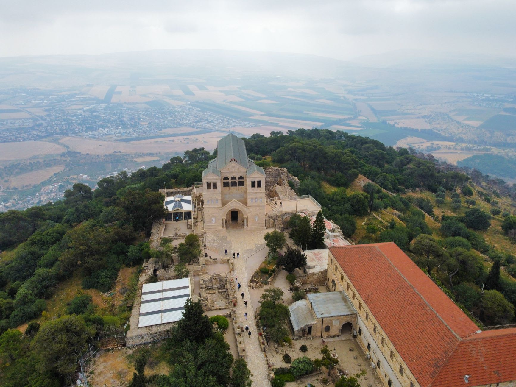 The Moses Memorial Church on Mount Nebo, its modern shelter roof protecting the ancient Byzantine mosaics inside, the valley stretching away beyond