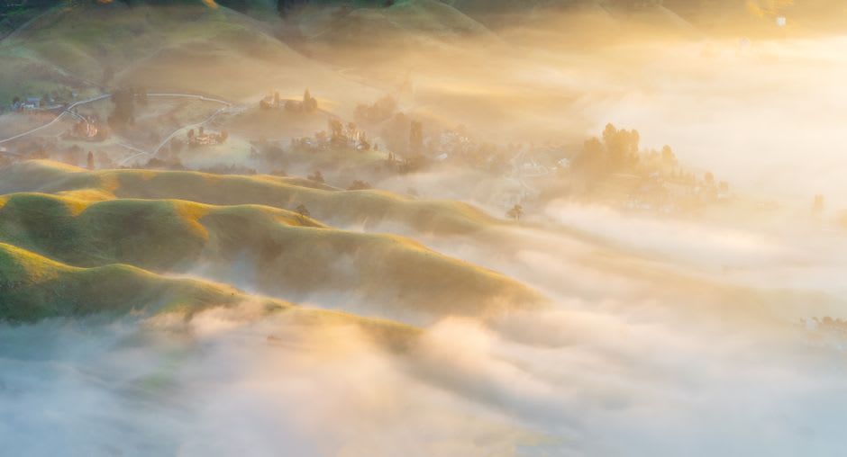 Mist rolling in low over Freshwater Lake, obscuring the far shore and surrounding peaks