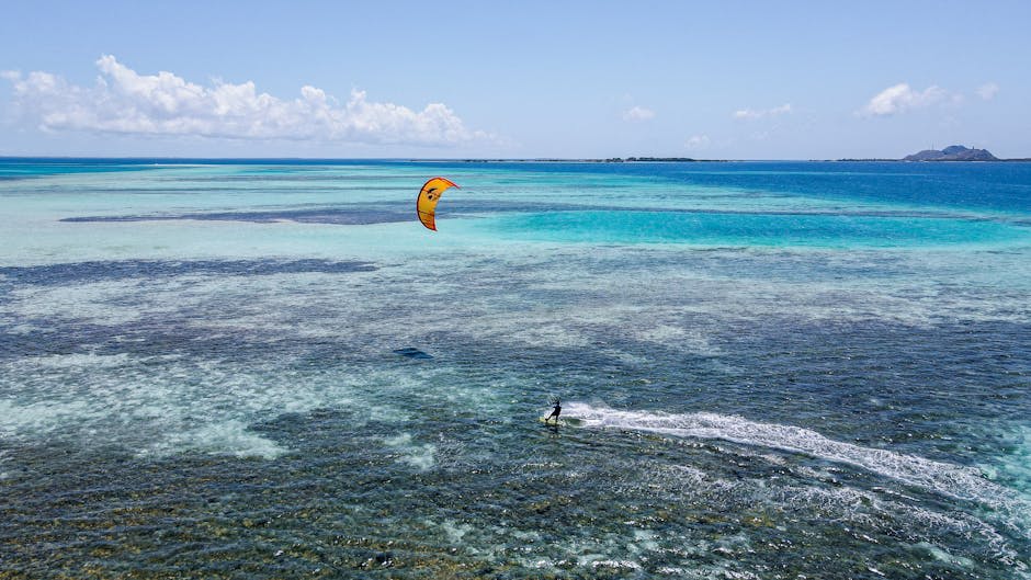 Colourful kites filling the sky over a Caribbean beach