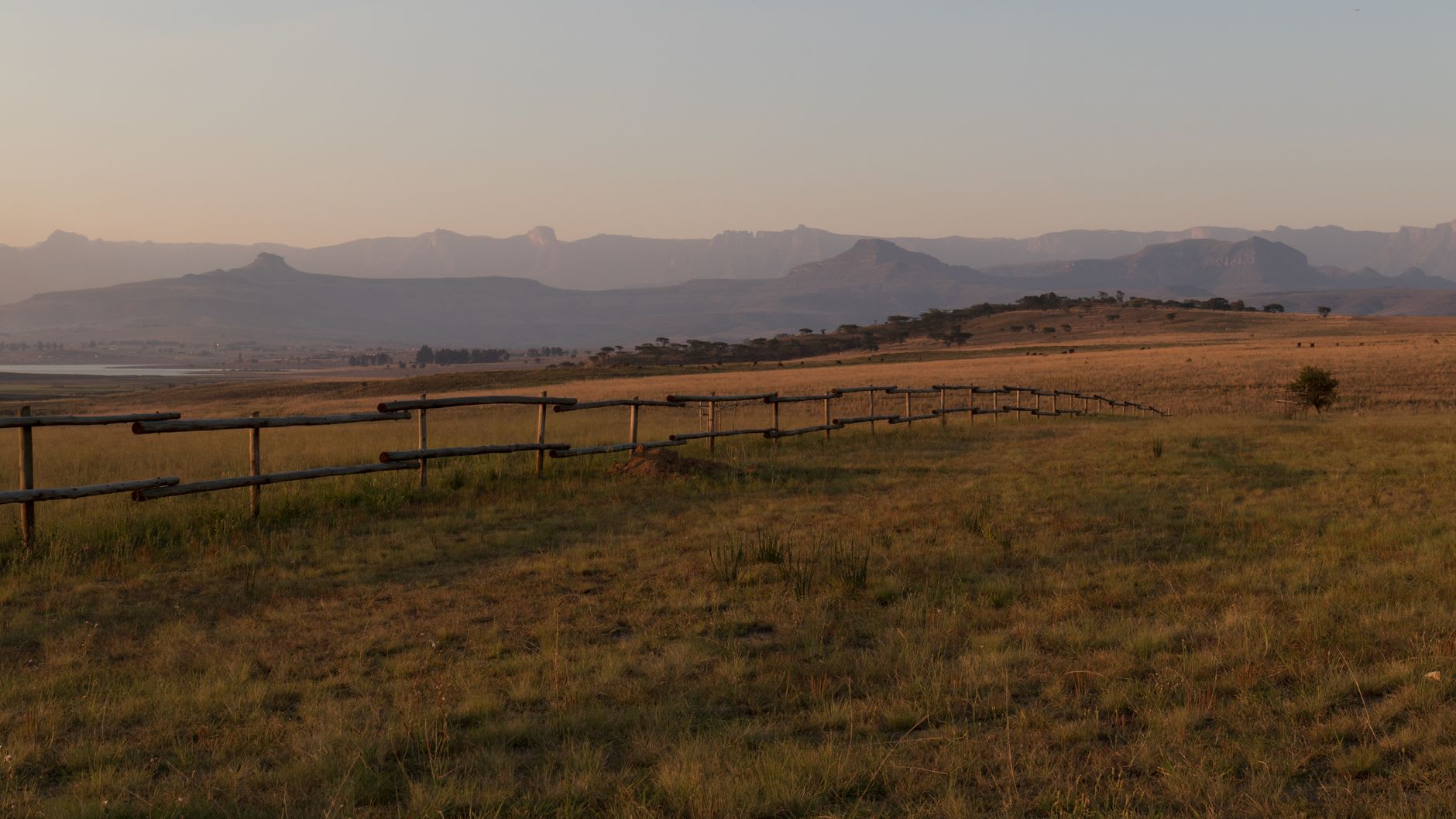 A clear trout stream winding through the open grassland of the Lotheni valley