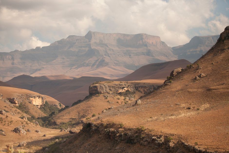 Sandstone cliffs of the Drakensberg escarpment seen from farmland near Underberg