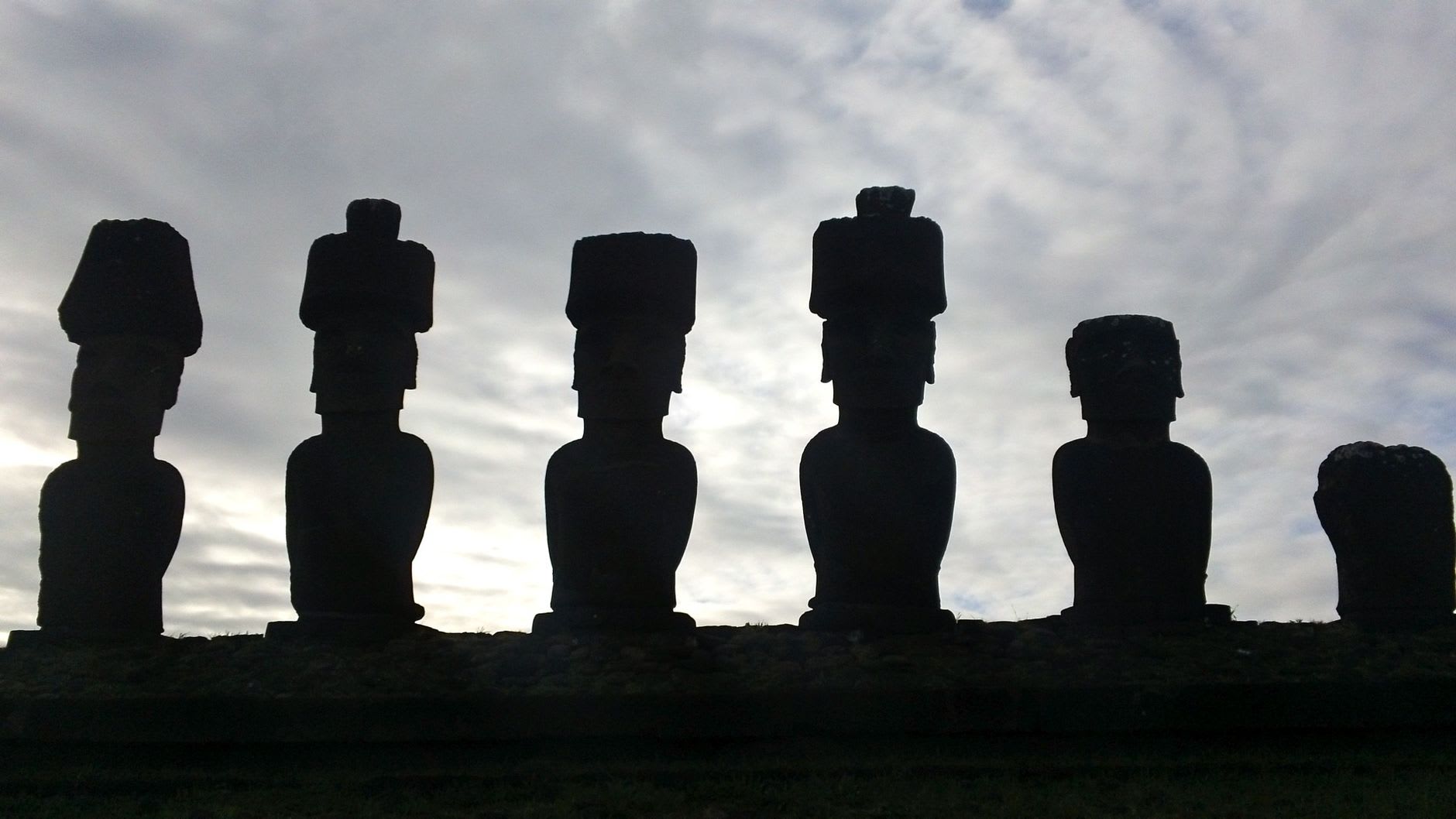 Ko Te Riku, the lone moai at Ahu Tahai with reconstructed coral eyes, at dusk with the Pacific Ocean behind him