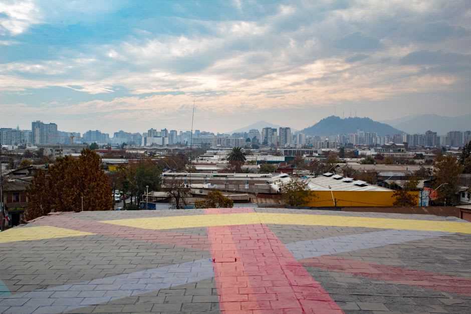 The city of Loja seen from a highland viewpoint with mountains rising behind the rooftops