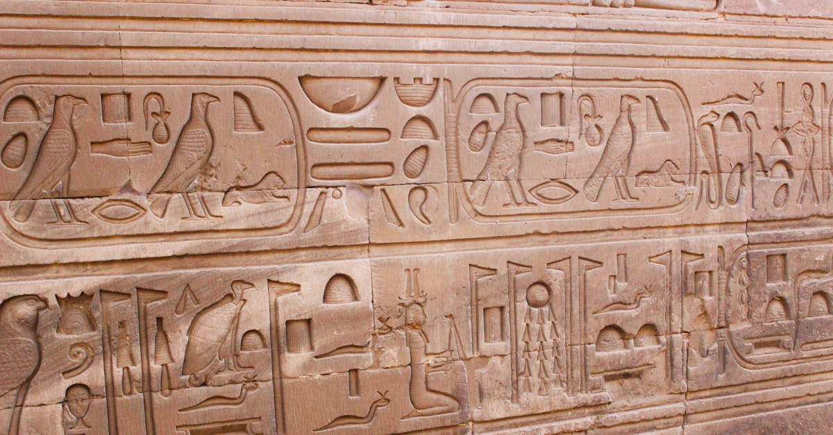 Traditional feluccas sailing the Nile at Aswan with golden desert hills