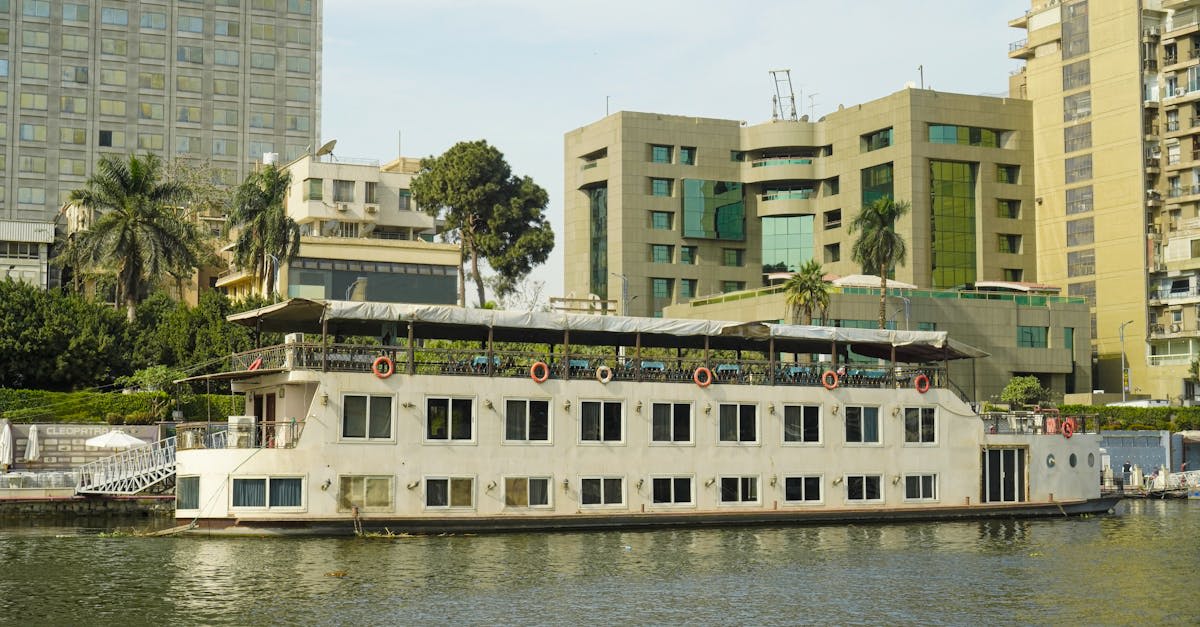 A traditional sailing vessel gliding along the palm-lined Nile