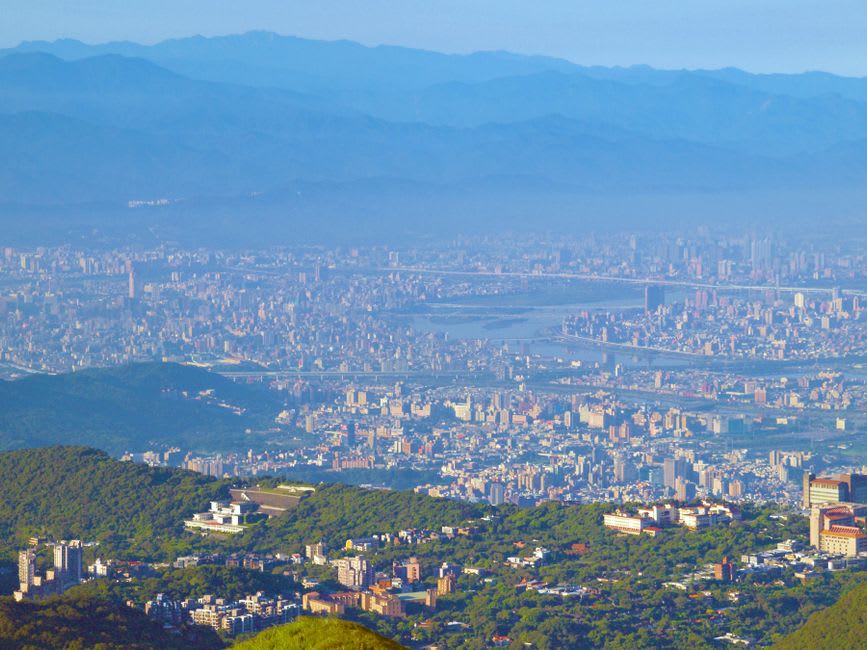A panoramic view of San Salvador's cityscape seen hazily from a viewpoint at El Boquerón National Park