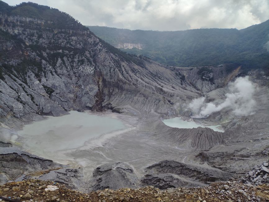 Steam rising from vents along the crater wall of Santa Ana volcano above the turquoise sulfur lake