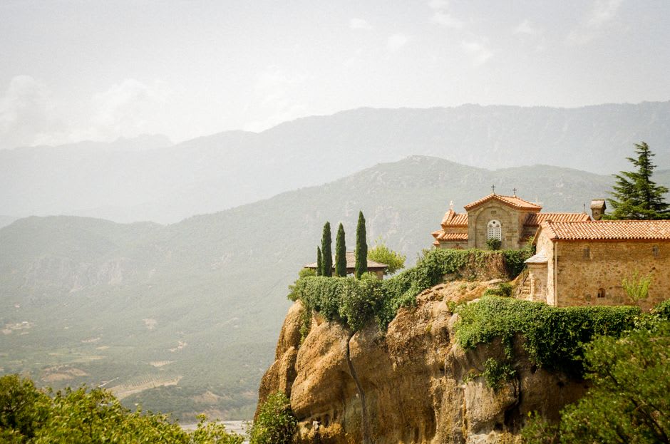 Stone walls of Debre Bizen monastery built into the mountainside above the escarpment