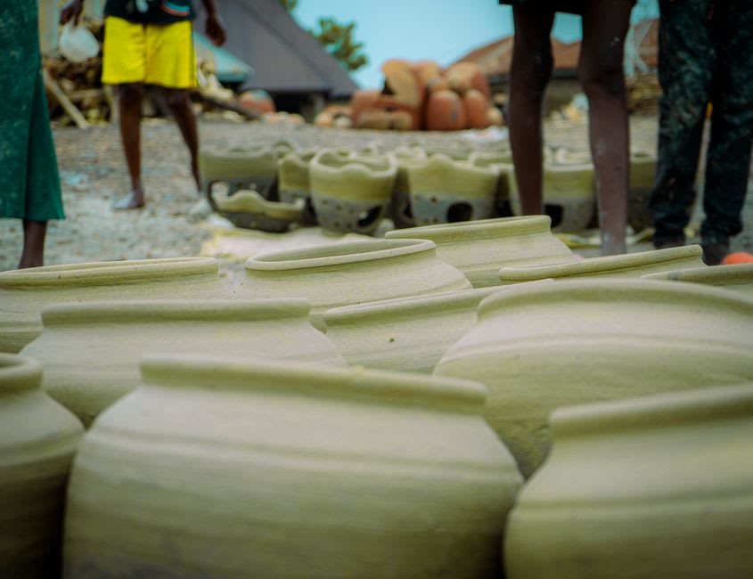 A potter in Lawai Village shaping clay by hand using the traditional paddle-and-anvil technique