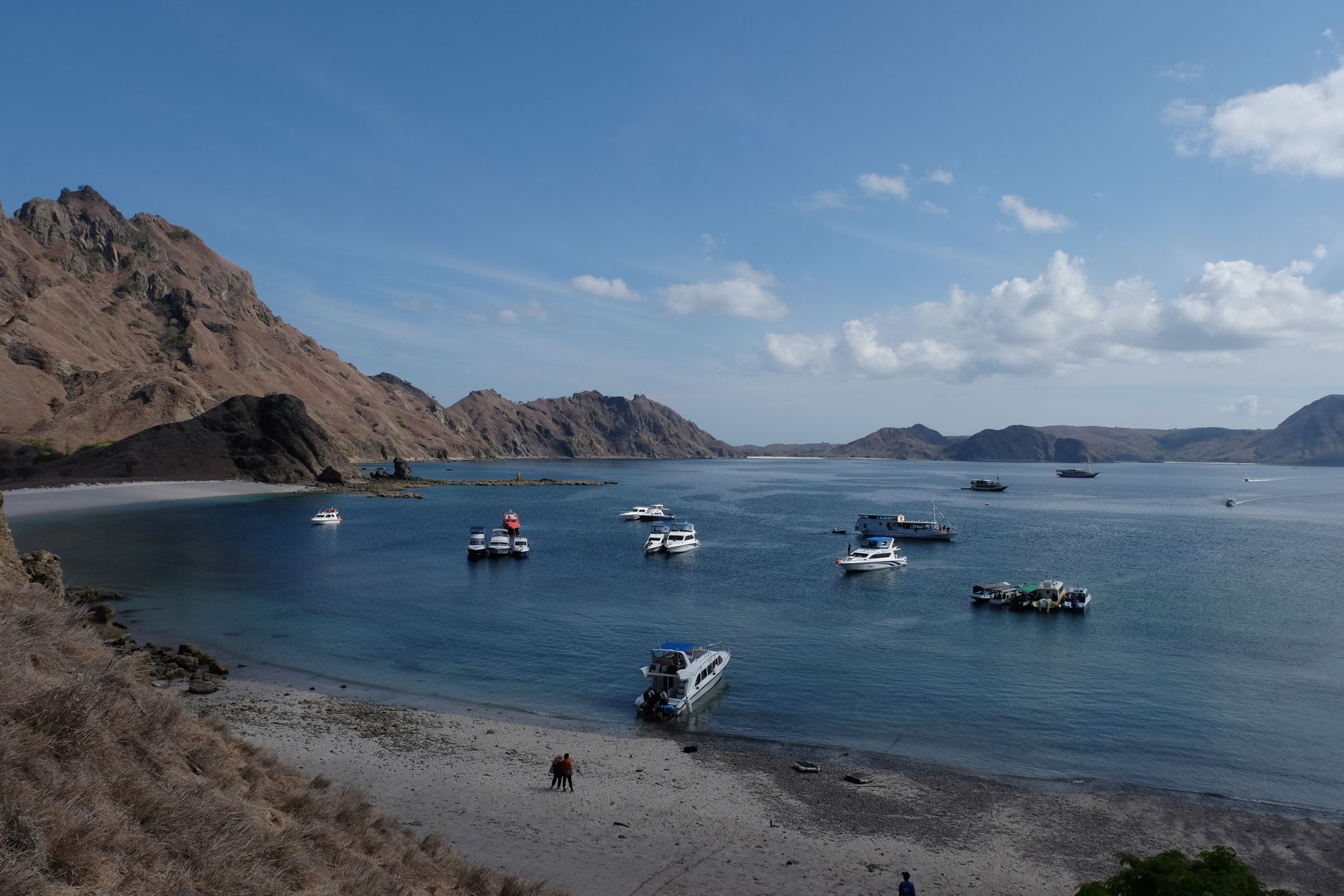 Colorful traditional jukung outrigger boats against the turquoise waters of Labuan Bajo harbor