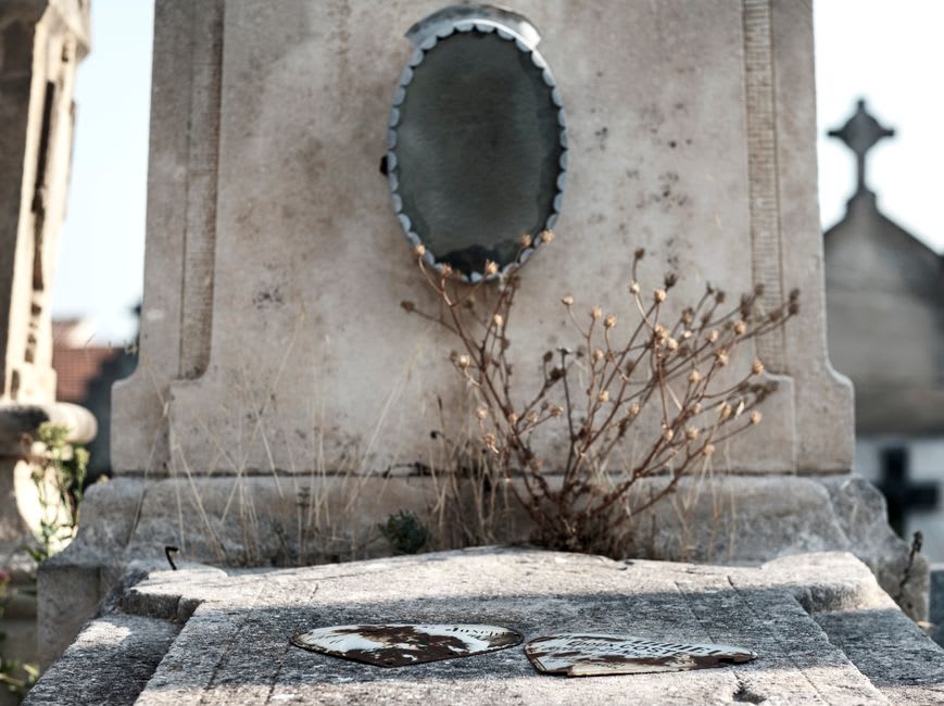 Round carved discoidal steles standing among the graves in Ainhoa's hillside cemetery beside the church