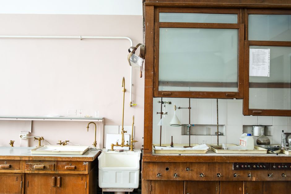 The preserved laboratory inside Louis Pasteur's house in Arbois, glass instruments arranged on wooden benches