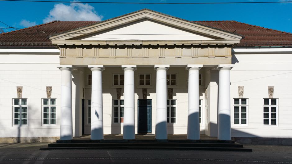 The colonnaded facade of the director's house at the center of the Saline Royale, its pediment carved with symbols of salt production