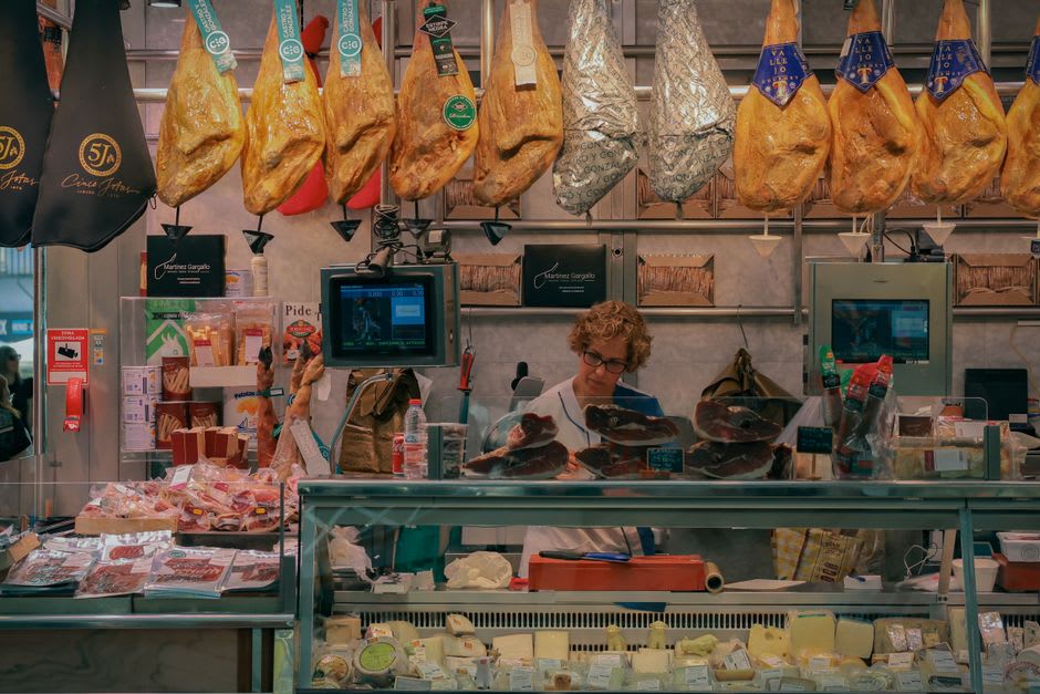 A weekly market stall in Argelès-Gazost selling local Pyrenean cheeses and honey