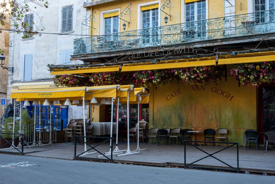 The bright yellow café façade on the Place du Forum in Arles at dusk