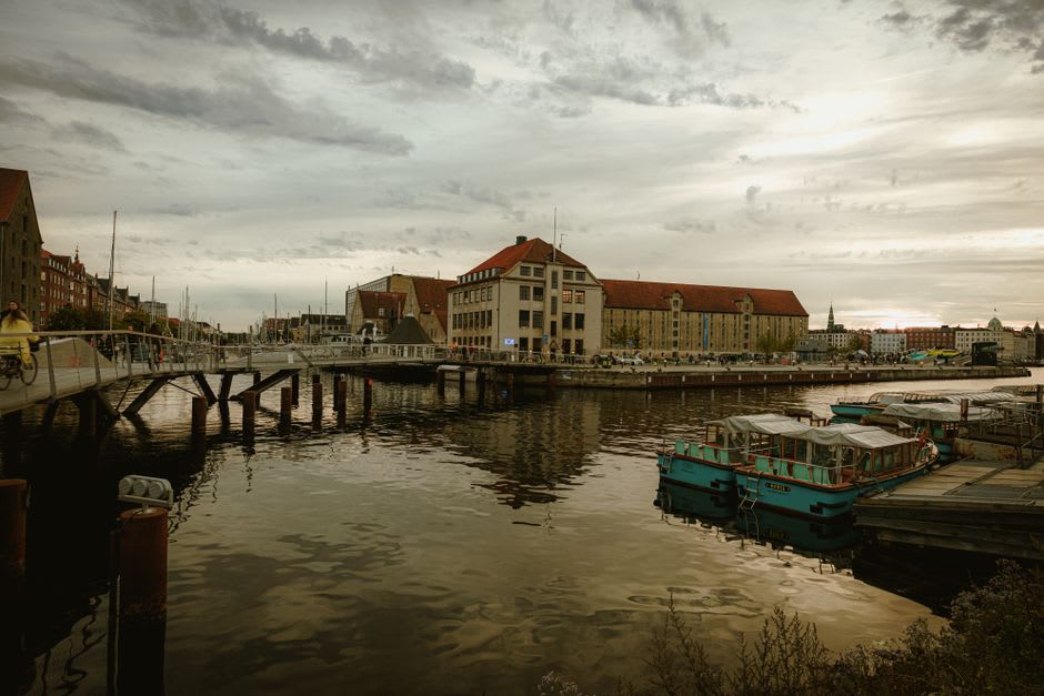 Boats moored along the quay of the Yonne river below the tiered rooftops of Auxerre's old town