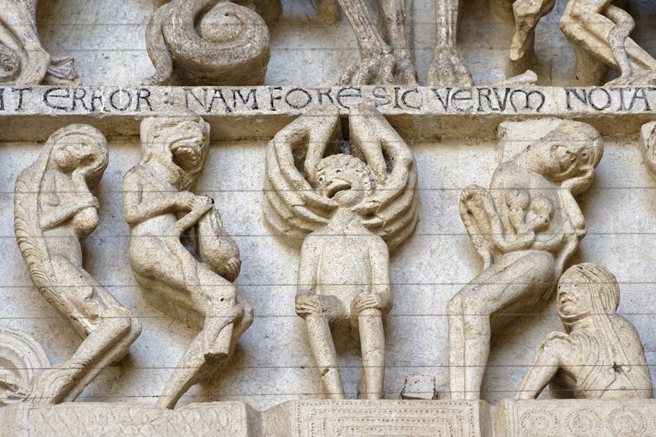 Densely carved Romanesque stone archways on the west front of the Collégiale Saint-Lazare in Avallon