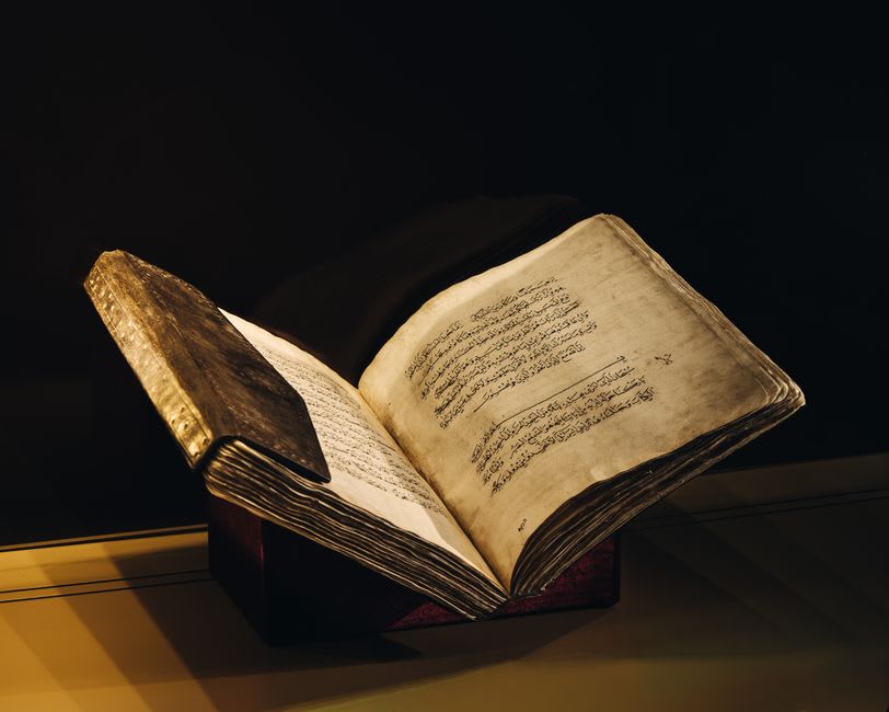 Illuminated medieval manuscript pages on display inside the Scriptorial museum in Avranches