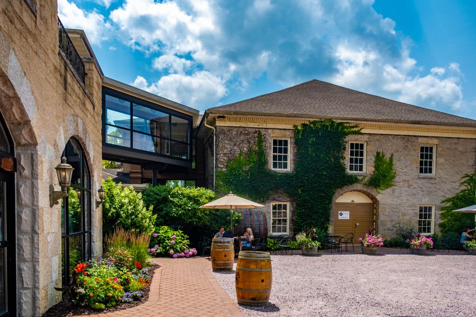Ivy-covered stone buildings and courtyard of the Bollinger champagne house in Aÿ