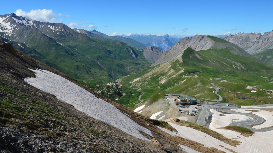 Cyclists climbing the switchbacks of the Col du Tourmalet above the treeline
