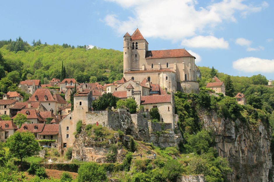 The Romanesque abbey buildings of Baume-les-Messieurs seen from the cliffside above the village