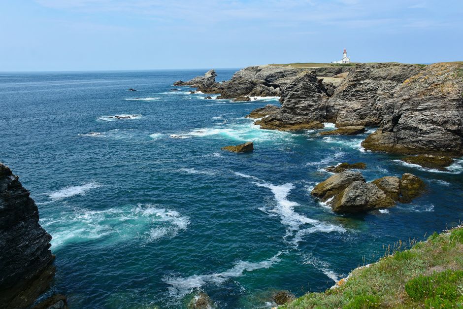 The jagged rock spires known as the Aiguilles de Port-Coton rising from foaming Atlantic waves on Belle-Île-en-Mer