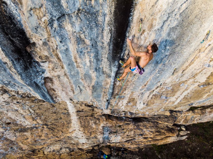 Climbers scaling a limestone cliff face in the Aiguebrun valley below Buoux