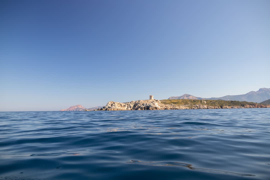 The Greek Catholic church of Cargèse with its distinctive bell tower against a clear Mediterranean sky