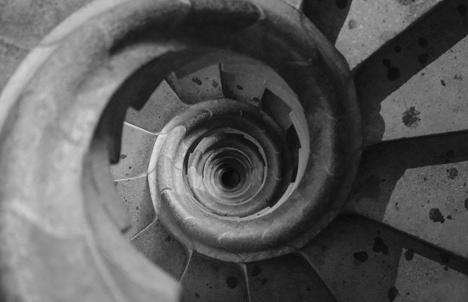The double-helix central staircase of Chambord viewed from below, spiraling upward through carved stone