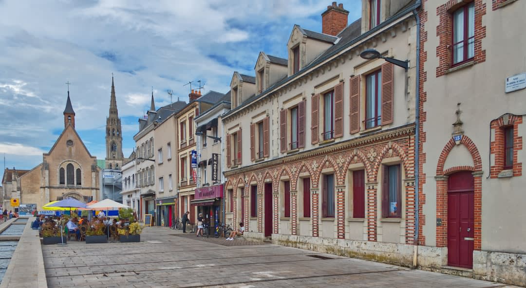 A steep cobbled street lined with medieval half-timbered houses in the old town of Chartres