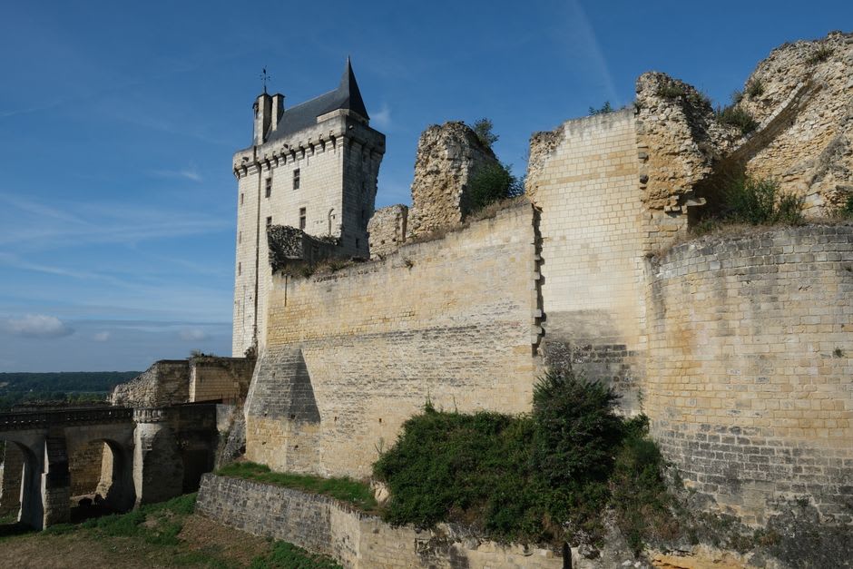 The ruined stone walls and window frames of the Salle de Réception at Chinon's fortress, open to the sky