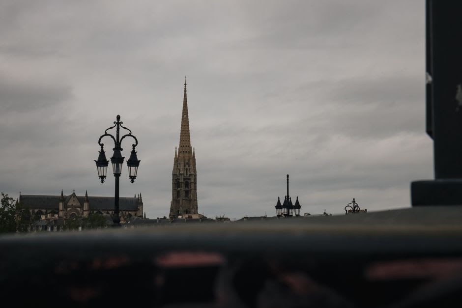 The dark twin spires of Clermont-Ferrand's black volcanic-stone cathedral against a grey Auvergne sky