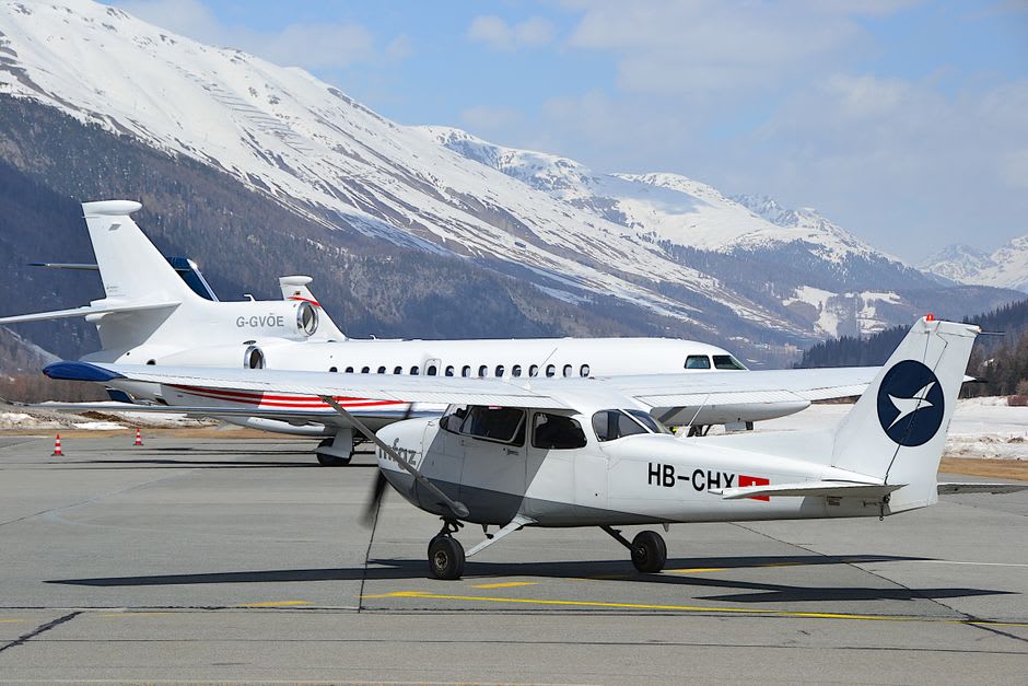 A small aircraft landing on the steep, snow-dusted uphill runway of Courchevel's mountainside airport
