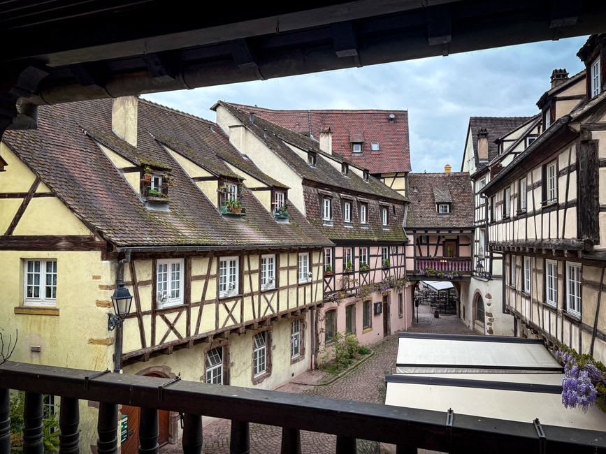 A half-timbered street in the old town of Domfront lined with leaning timber-framed houses