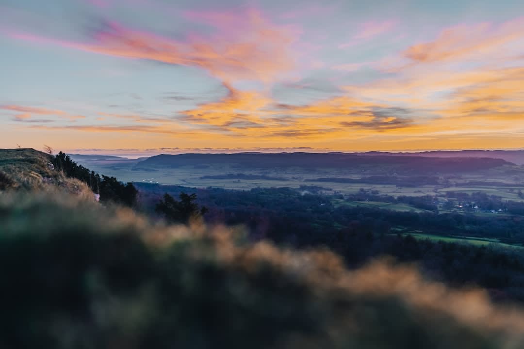 The view along Domme's clifftop ramparts path over the Dordogne River valley at sunset