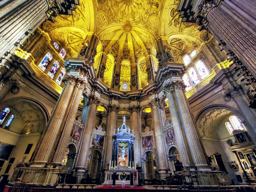 The gilded, painted ceiling and stained glass windows of the Renaissance chapel inside the Château d'Écouen