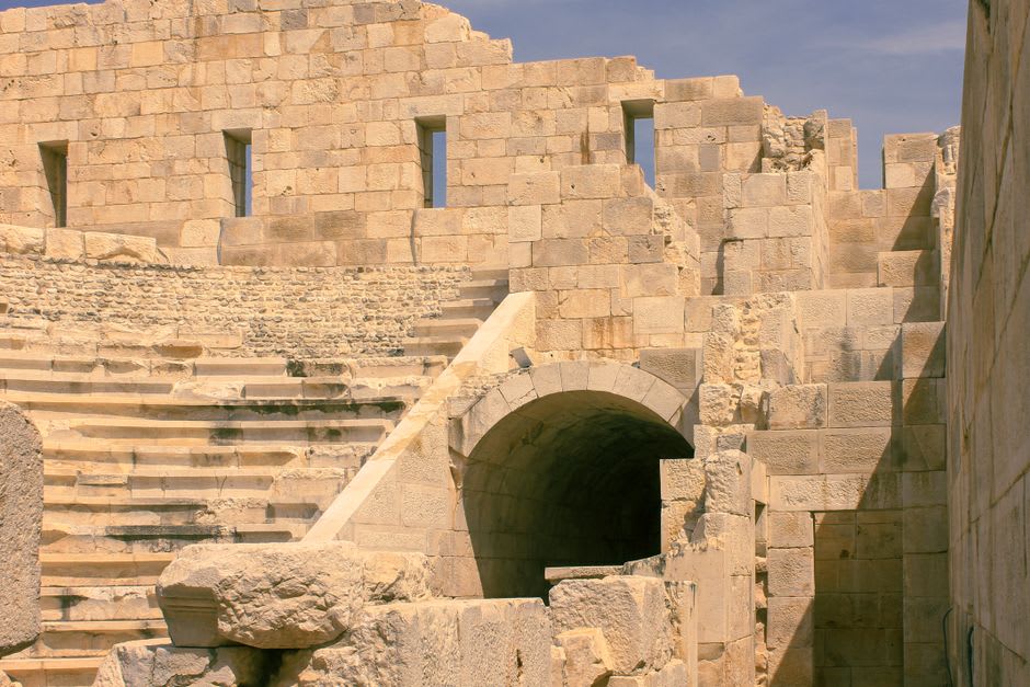 The weathered stone tiers and arched entrances of the Roman amphitheater in Fréjus