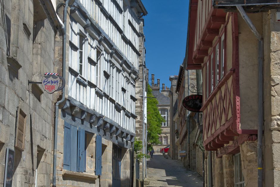 Half-timbered houses and the collegiate church along a narrow street inside Guérande's old walls