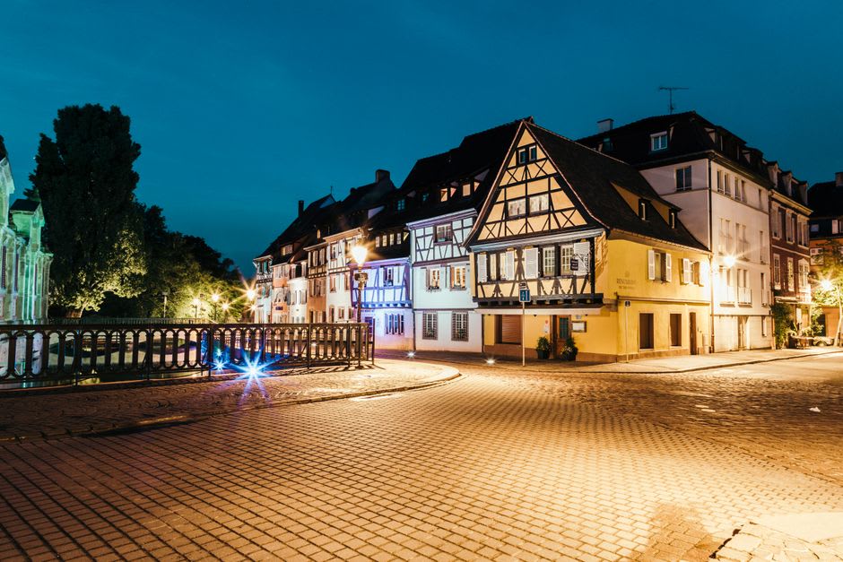 A quiet cobbled street in Kaysersberg lined with half-timbered houses near Albert Schweitzer's childhood home