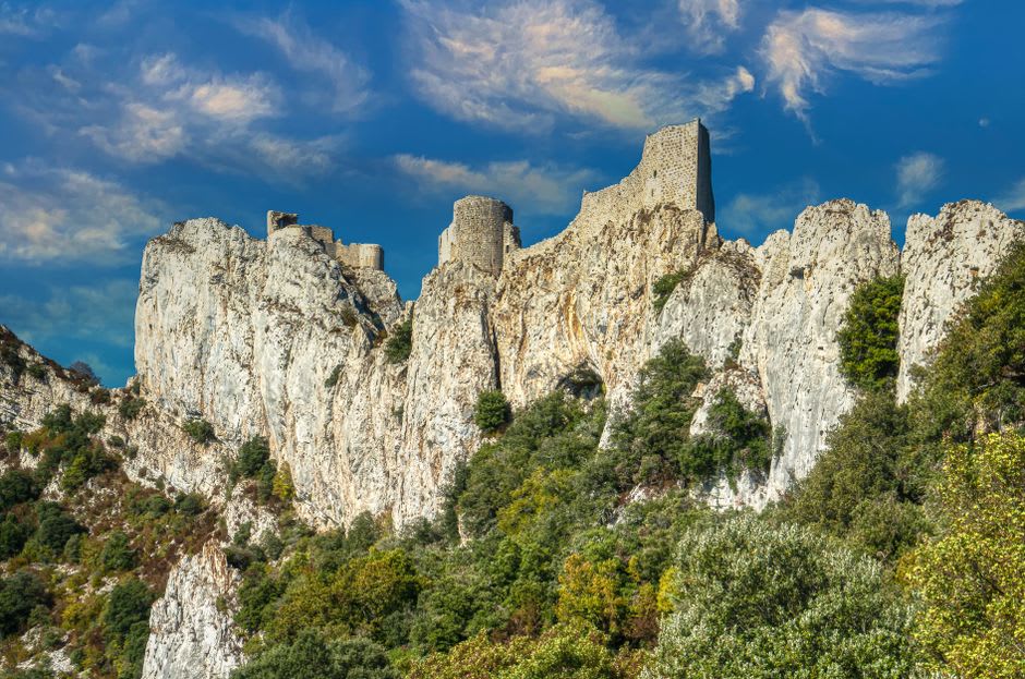 The white limestone ruins of the medieval Château des Baux fused into the rock spur above the village