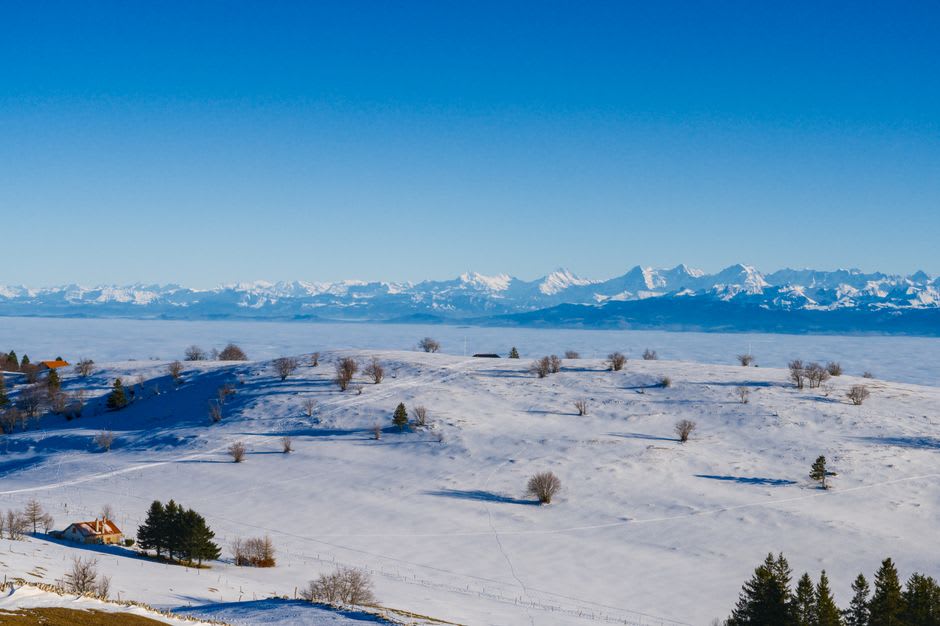The snow-covered ramparts of Fort des Rousses against the flat white expanse of the high Jura plateau