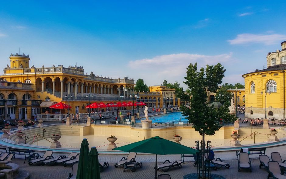 The green lawns and old bathhouse building of the Parc des Bains thermal park in Lons-le-Saunier