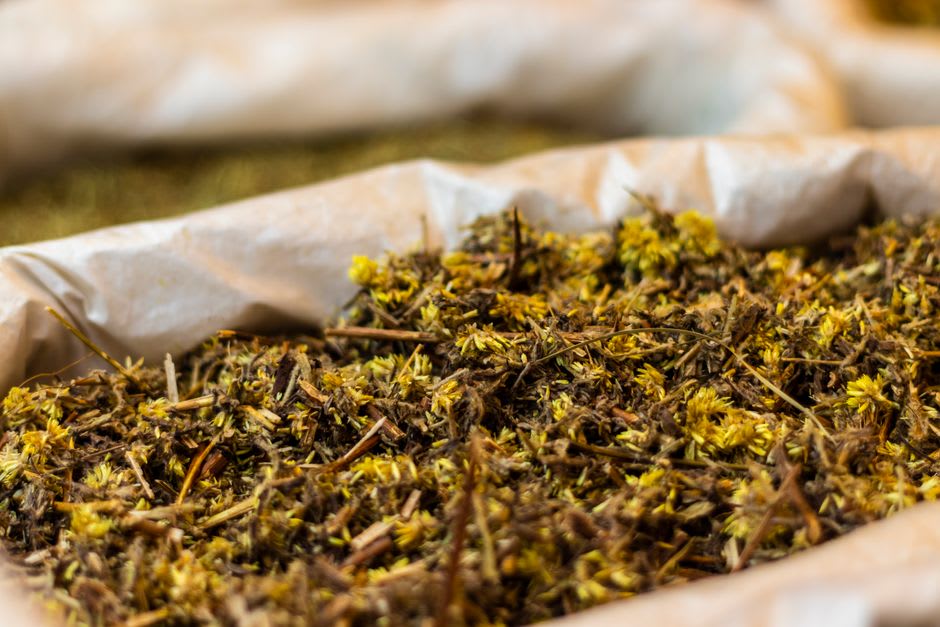 Rows of dried medicinal herbs and plants for sale under the old covered market hall, the Halle aux Simples, in Milly-la-Forêt