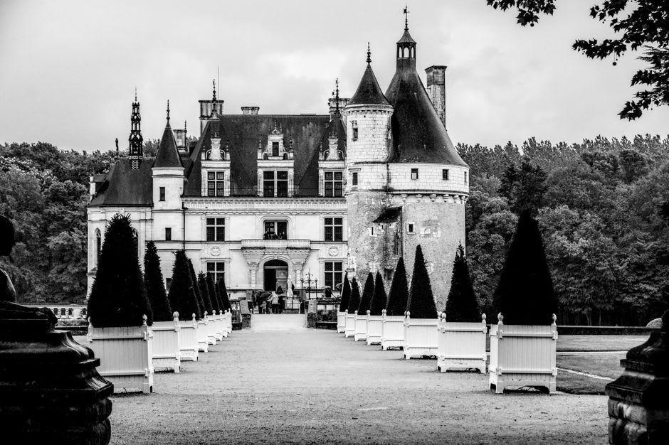 The white tuffeau stone facade of the Château de Montsoreau viewed from the riverside path along the Loire
