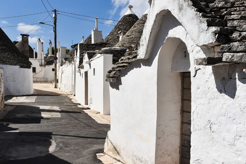 A whitewashed troglodyte house cut into the limestone cliff face in the village of Montsoreau