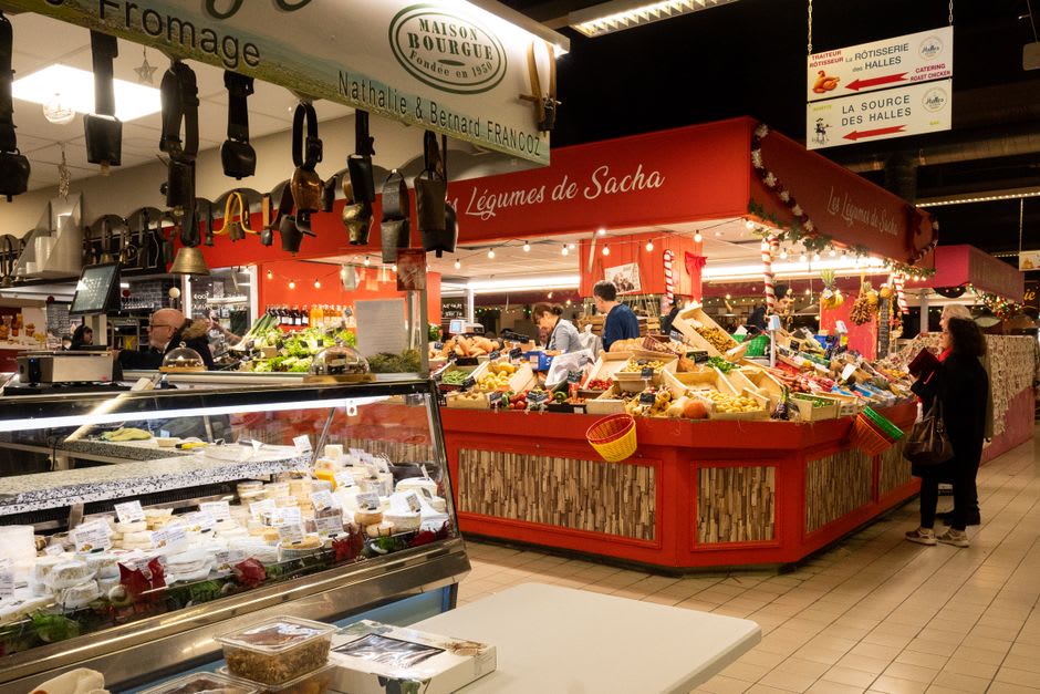 Wooden market stalls selling cassis, mustard, and cheese on a Friday morning in Nuits-Saint-Georges